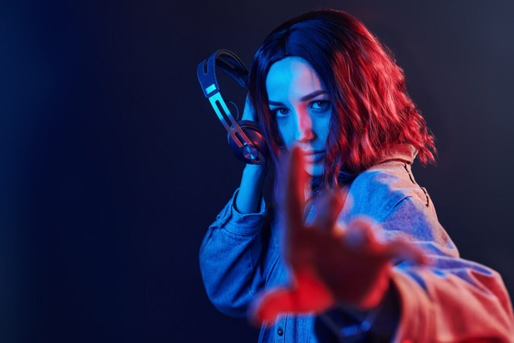Portrait Of Young Girl That Listening To Music In Headphones In Red And Blue Neon In Studio 1024x683
