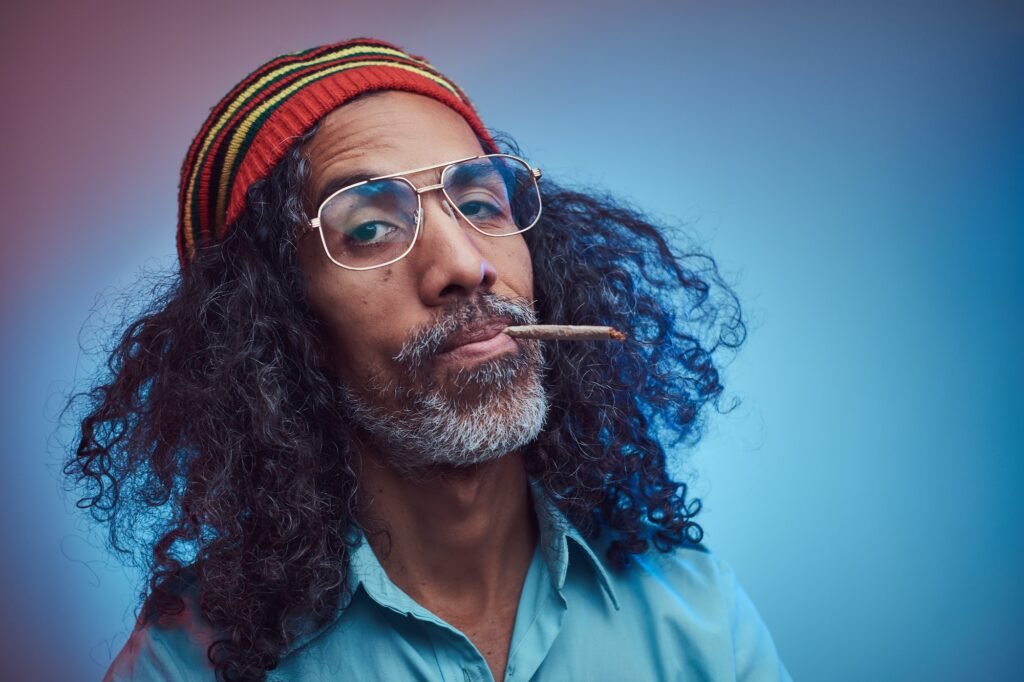 Studio Portrait Of African Rastafarian Male Smoking Cigarettes 1024x682